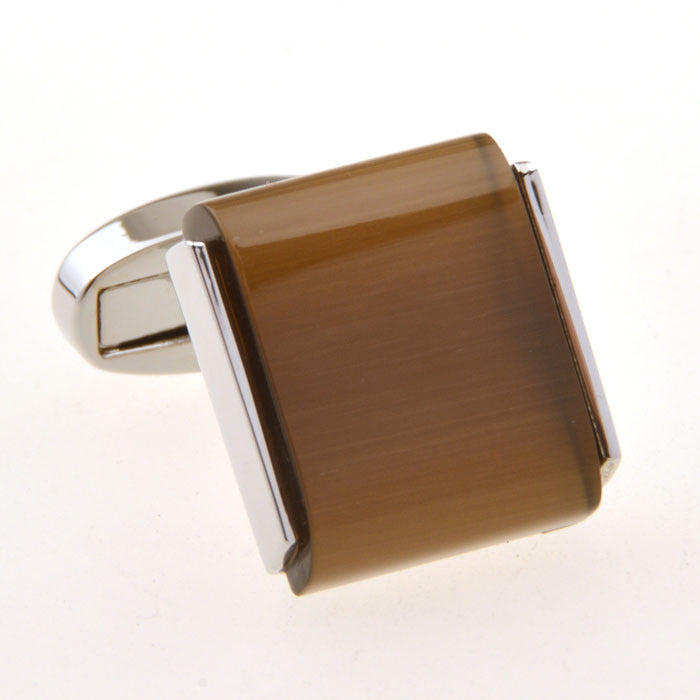 one single brown cufflink white background