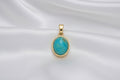 blue stone gold setting with white background