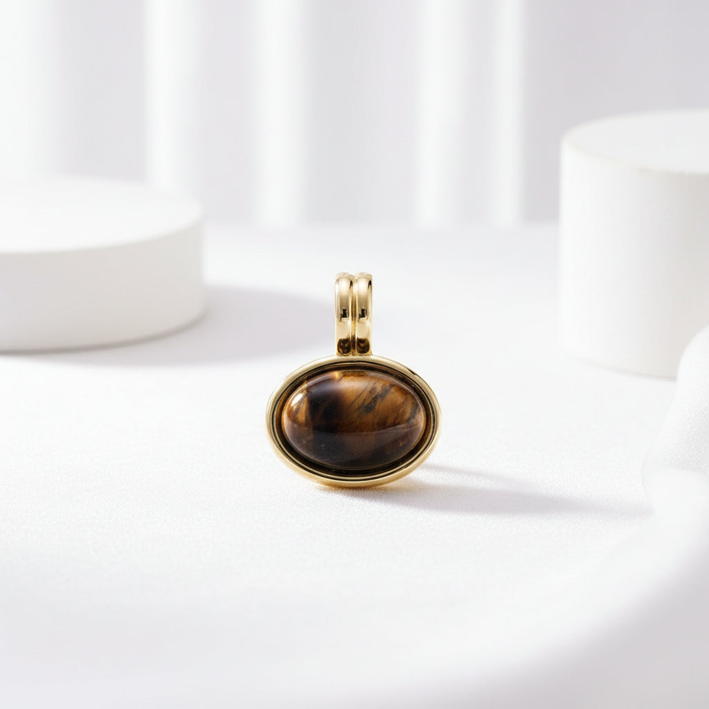 brown stone in gold setting with white background