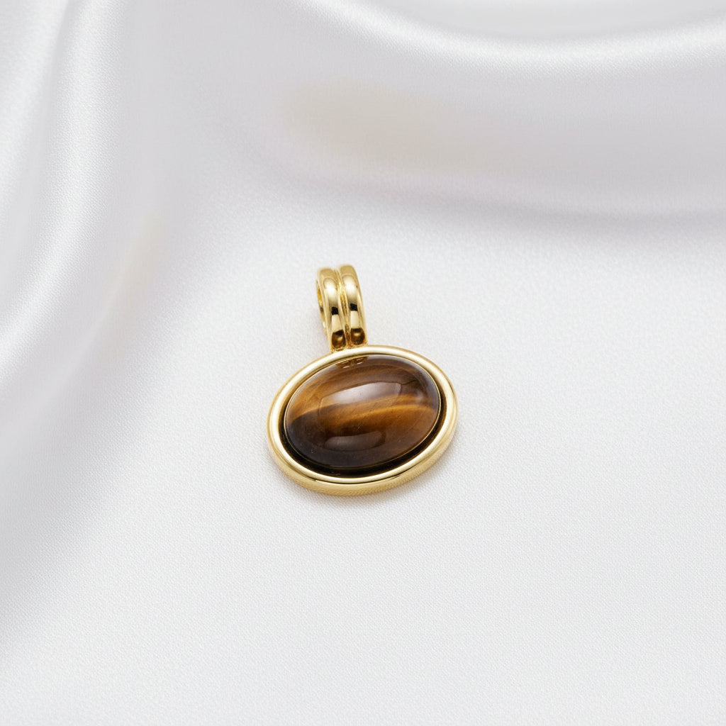 brown stone in gold setting with white background