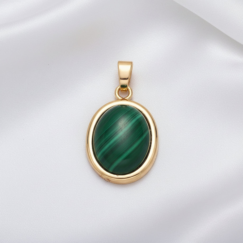 Gold pendant with a green stone on a white background
