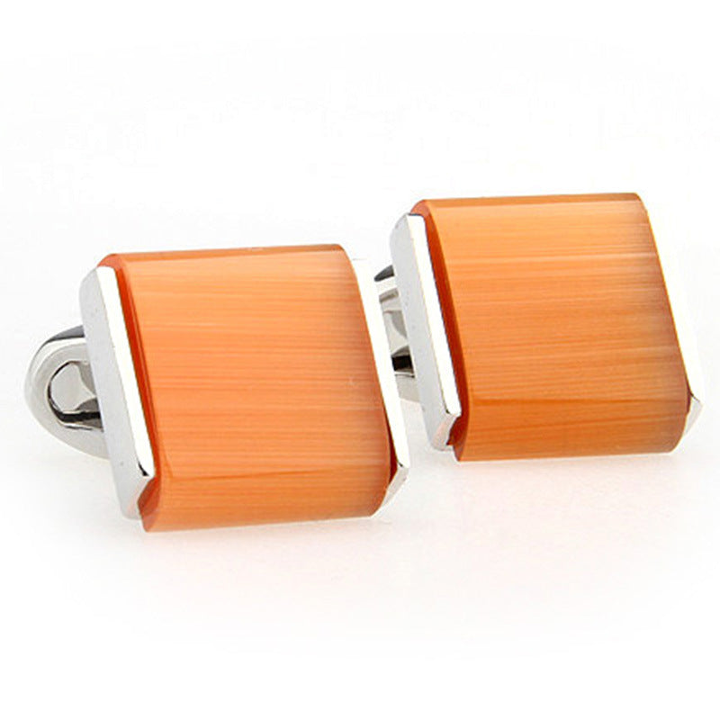 orange cufflinks white background