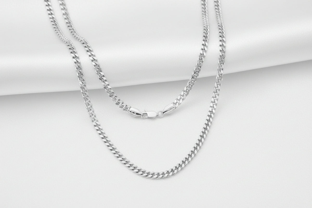 A silver-toned metal chain necklace with a lobster clasp, shown against a plain white background.