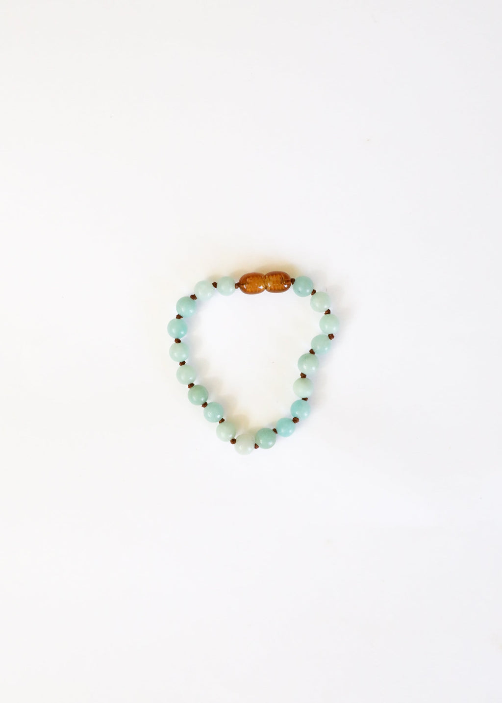 Beaded bracelet with a wooden bead on a white background