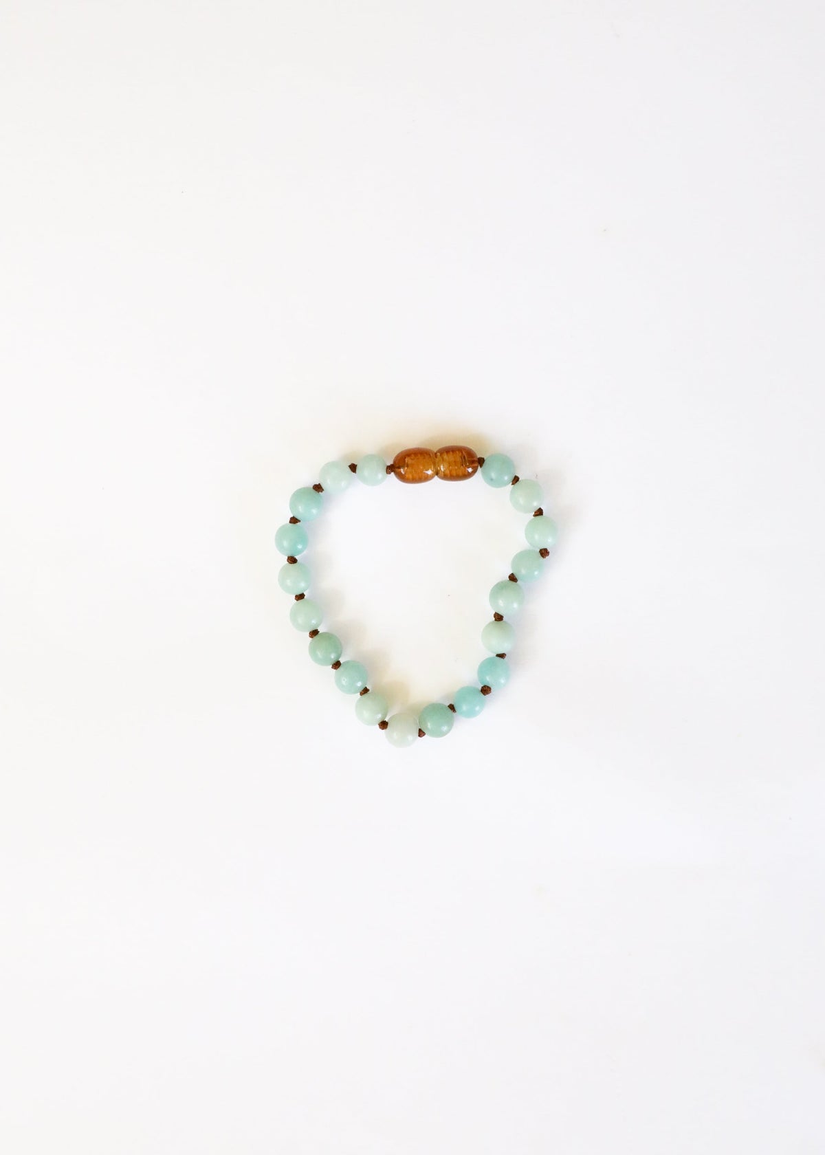 Beaded bracelet with a wooden bead on a white background