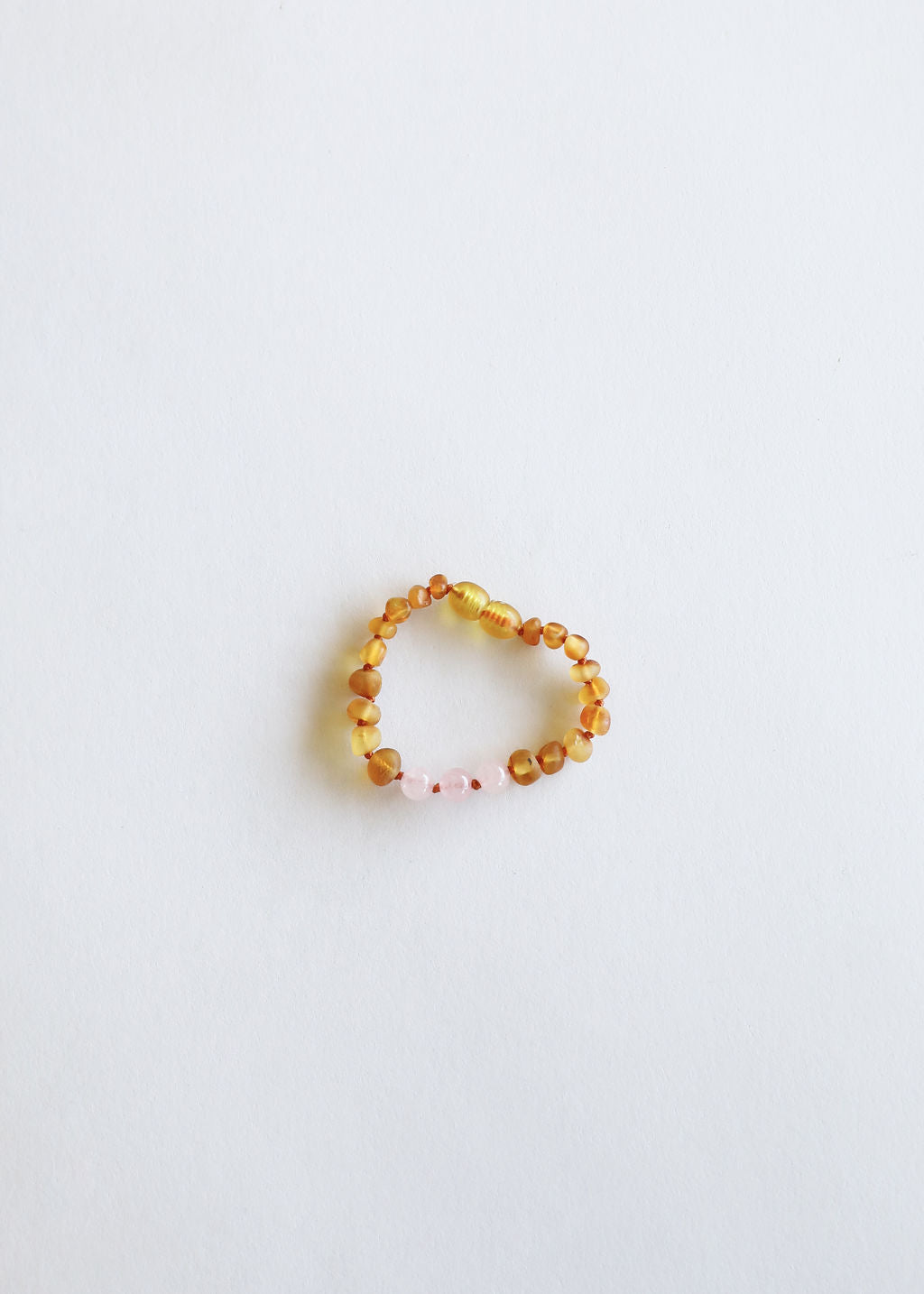 Yellow beaded bracelet on a light gray background