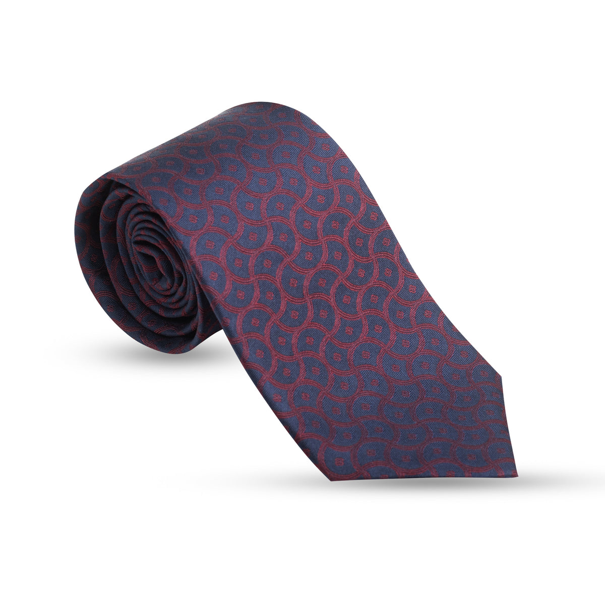 A rolled necktie with a repeating geometric pattern in navy blue and red, displayed on a clean white background.