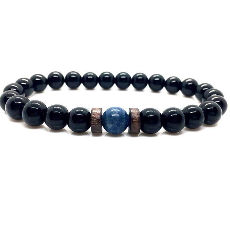 Black beaded bracelet with a blue stone and wooden accents on a white background