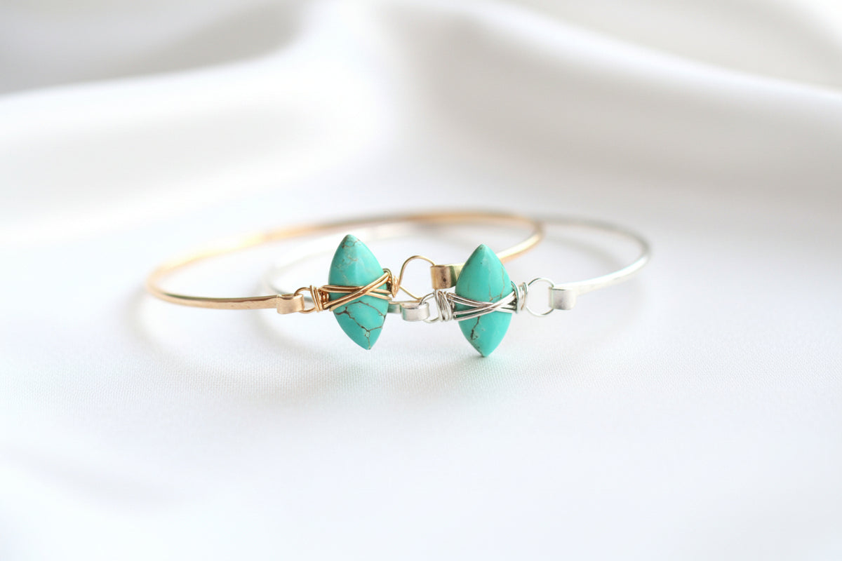 gold and silver with stone bracelet on silky white  background