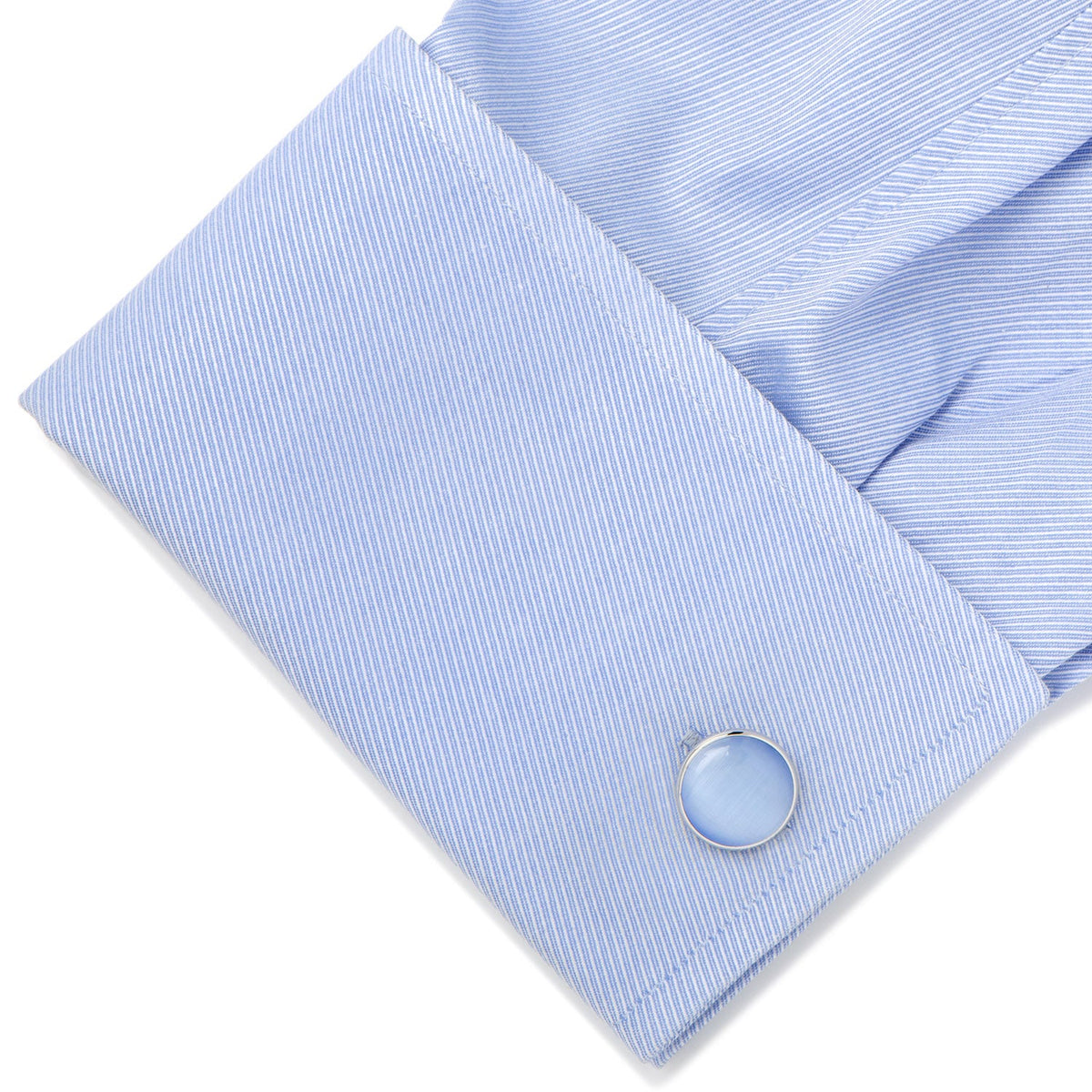 blue cufflink on blue shirt sleeve white background