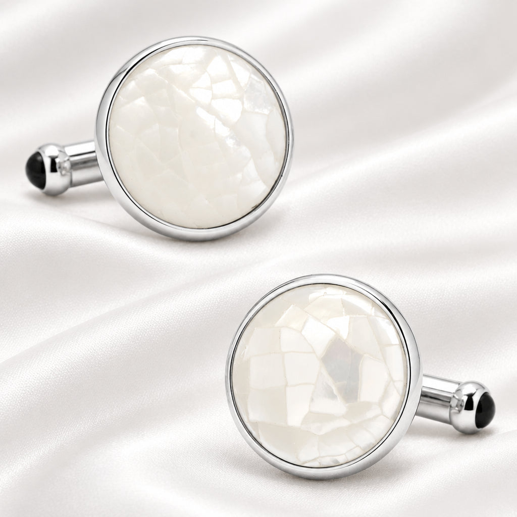 Round cufflinks with white center and silver border on a white background