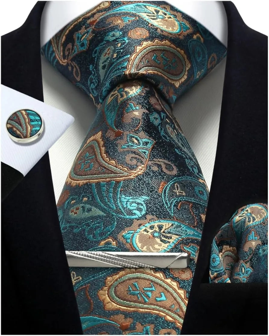 Teal and gold paisley tie set with matching pocket square and cufflinks on a suit.