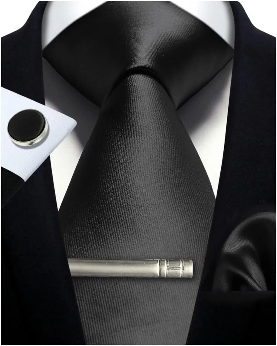 Black tie with a tie clip on a suit background
