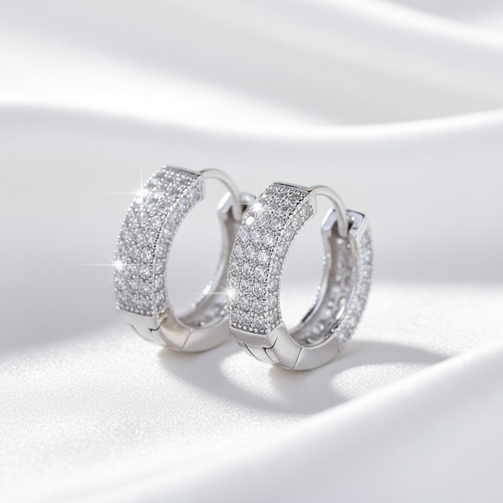 Two silver-toned cuff bracelets covered in clear pavé stones, 