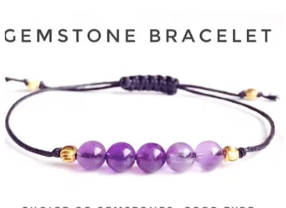 Purple gemstone bracelet with gold accents on a white background