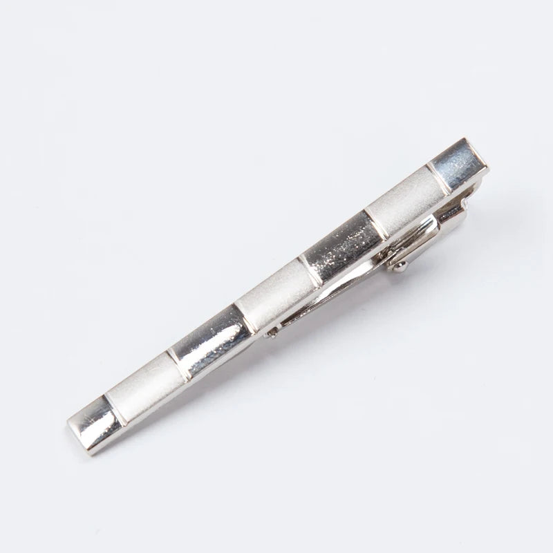 Silver tie clip on a white background