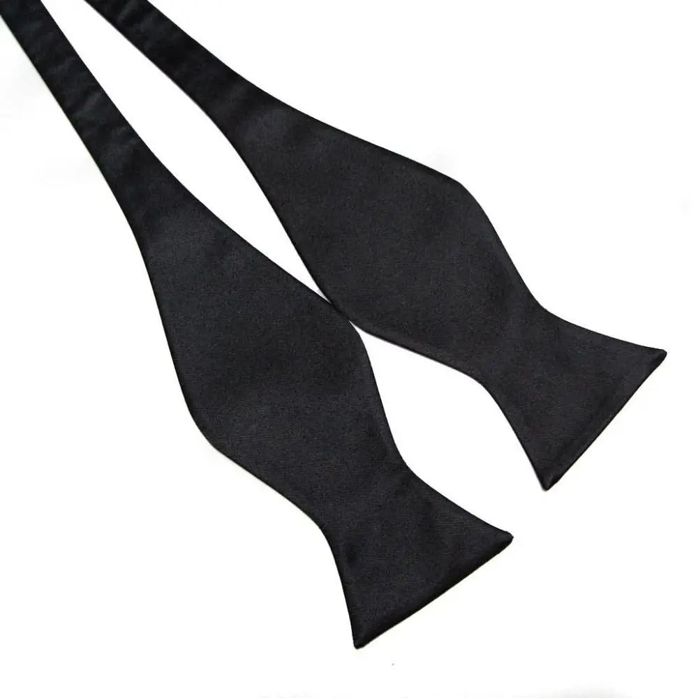 Two black bow ties on a white background