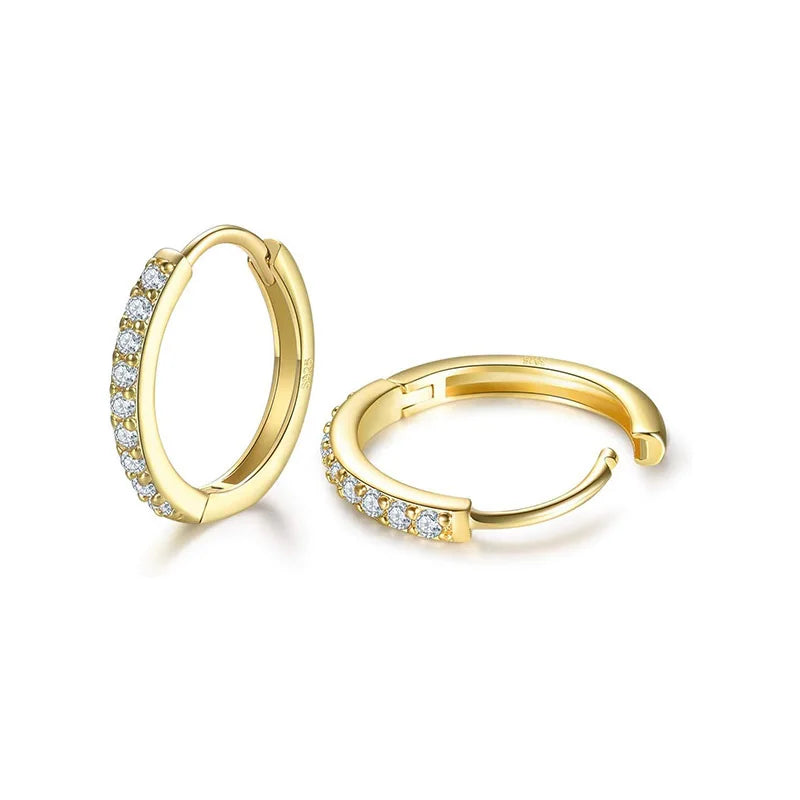 A pair of gold huggie hoop earrings with pavé-set clear stones along the front curve, displayed on a clean white background.