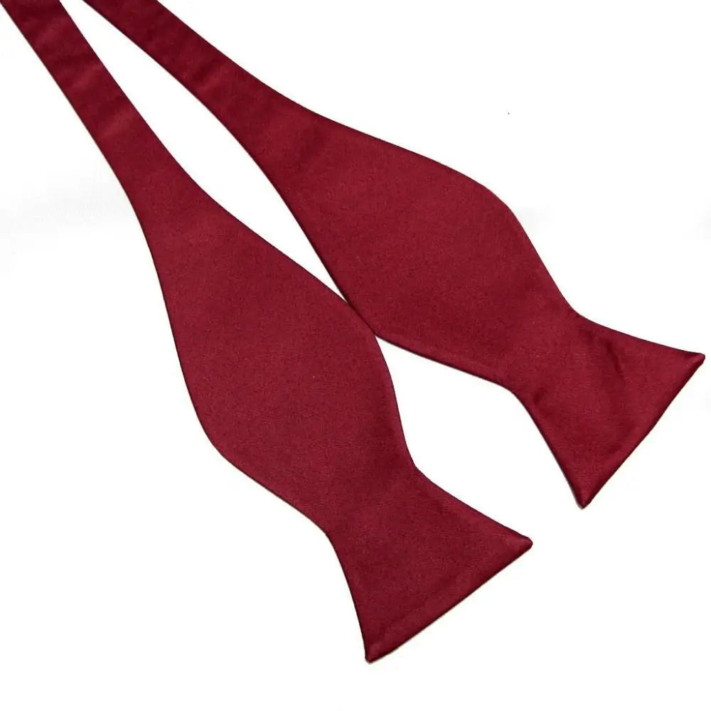Two black bow ties on a white background