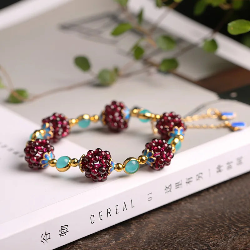 Bracelet with red and gold beads on a magazine page