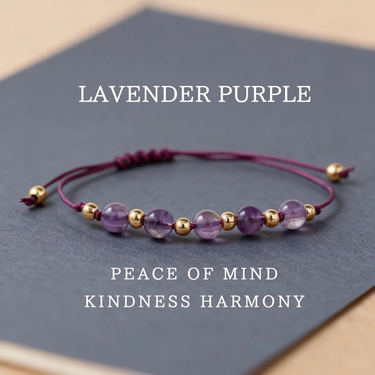 Lavender purple beaded bracelet with gold accents on a dark surface, text indicating color and associated words.