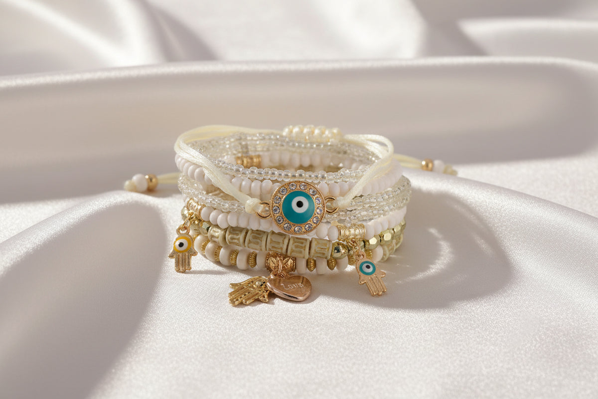Set of beaded bracelets with charms on a white background