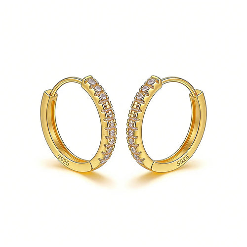 Gold hoop earrings with embedded stones on a white background