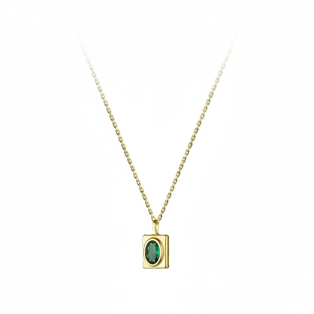 A gold necklace with a rectangular pendant featuring an oval green gemstone, shown on a plain white background with a red 'REAL STERLING 925' stamp in the lower right corner.