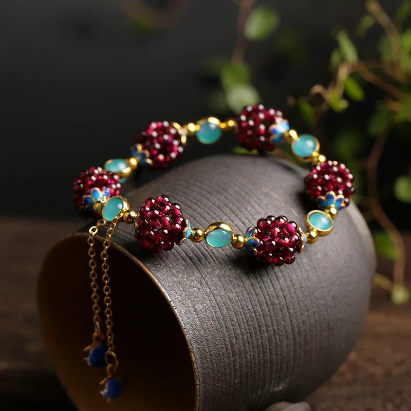 Bracelet with red and blue beads on a dark surface