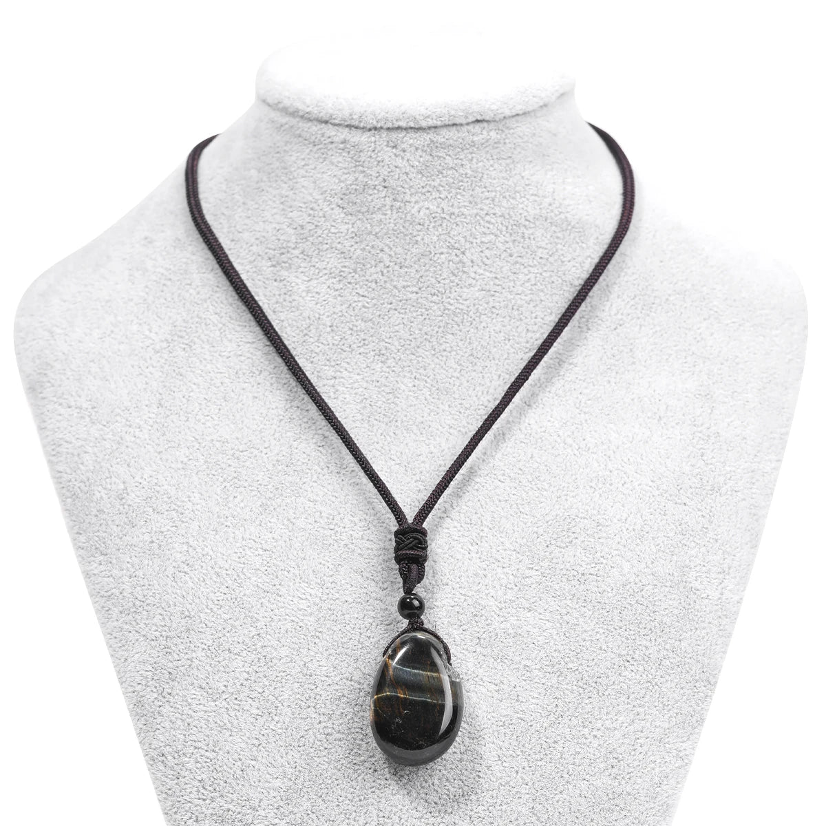 Necklace with a black pendant on a mannequin bust against a white background