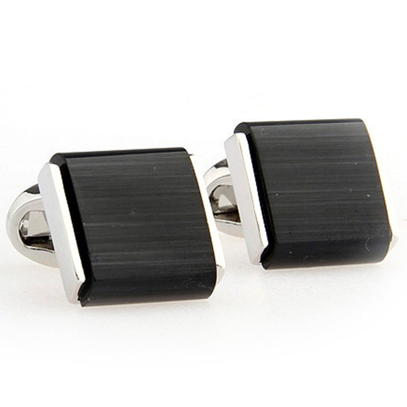 black cufflinks on white background