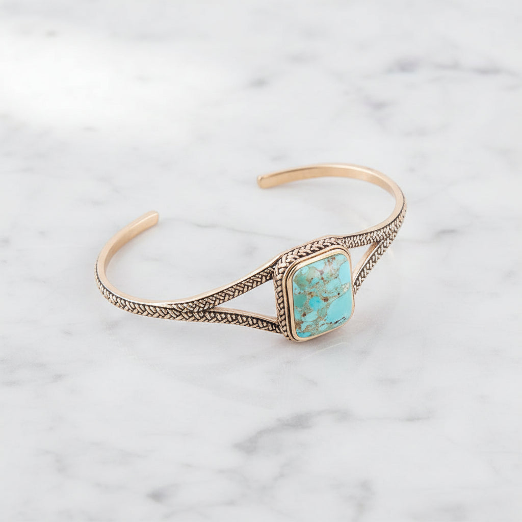 cuff turquoise bracelet with whie marble backgrpund