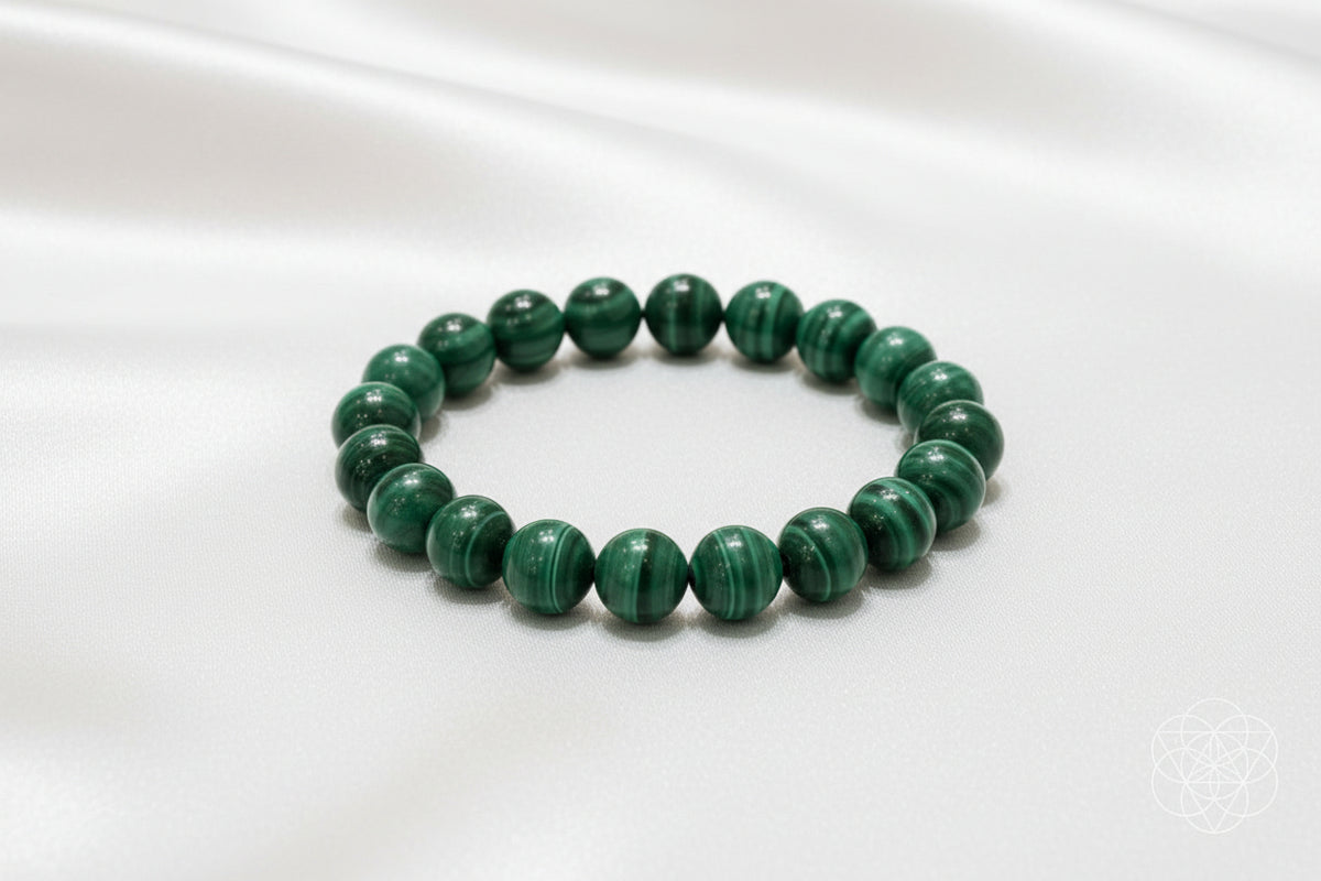 green bead bracelet with white silk background