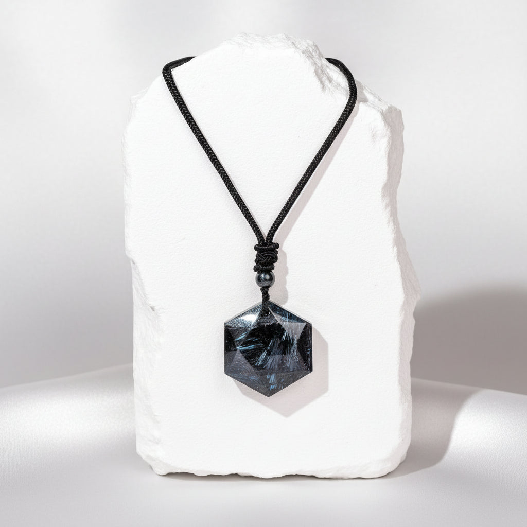 Necklace with a black pendant on a white stone with a white background