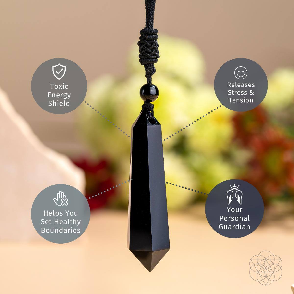Black pendant with wellness benefits text on a blurred nature background