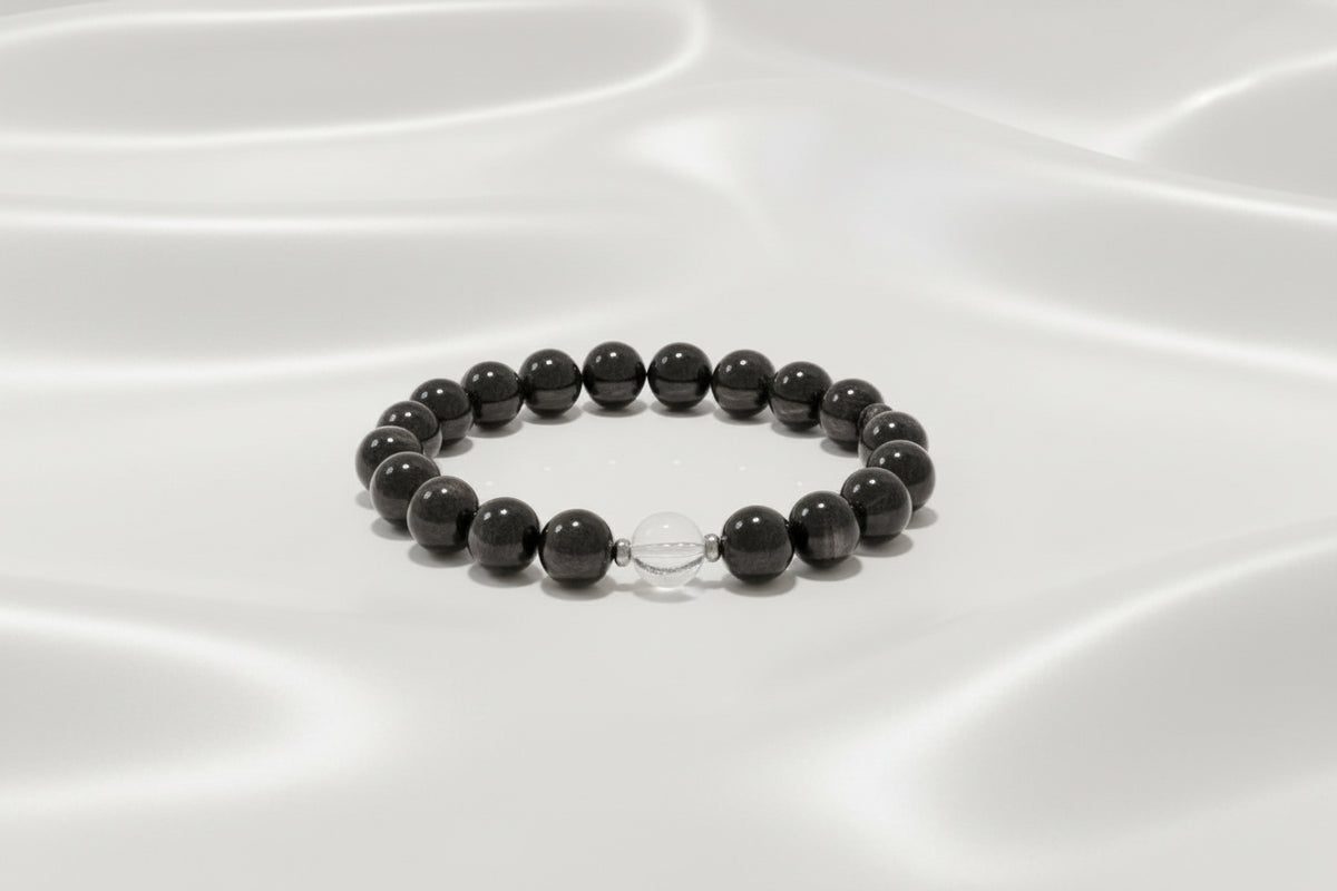 black and clear bead bracelet on white silky background
