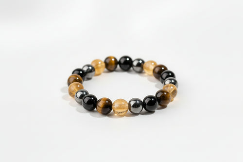 A beaded stretch bracelet made of alternating polished black and golden-yellow round beads, displayed on a white background.